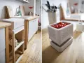 Un frigo sans électricité, un concept ingénieux pour conserver les aliments. Ici, des tomates cerises dans un récipient ajouré, sur un plan de travail en bois.