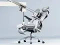 Fauteuil ergonomique médecine du travail, au design futuriste, avec repose-pieds déployé et appui-tête réglable.