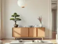 Un salon à l'inspiration japonaise avec un buffet en bois clair, un bonsaï, des vases et une lanterne.