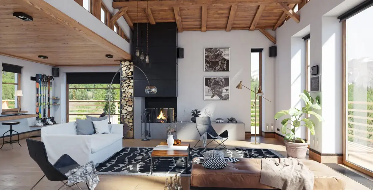 Ambiance chaleureuse d'un **chalet intérieur** avec cheminée, canapé blanc, fauteuil design et vue sur la montagne.