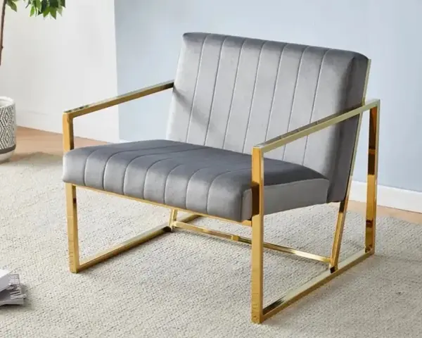 Fauteuil moderne gris velours avec structure dorée, un exemple élégant parmi les différents types de fauteuils pour un salon chic.