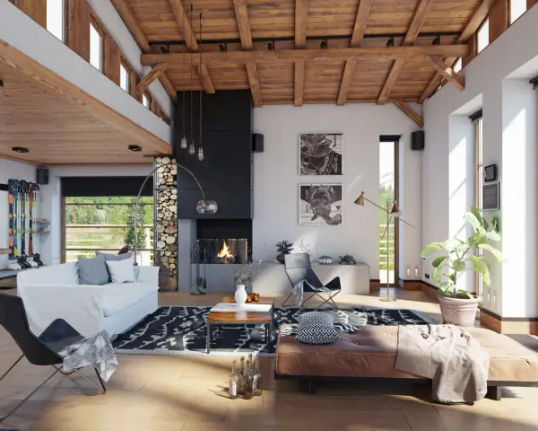 Ambiance chaleureuse d'un **chalet intérieur** avec cheminée, canapé blanc, fauteuil design et vue sur la montagne.