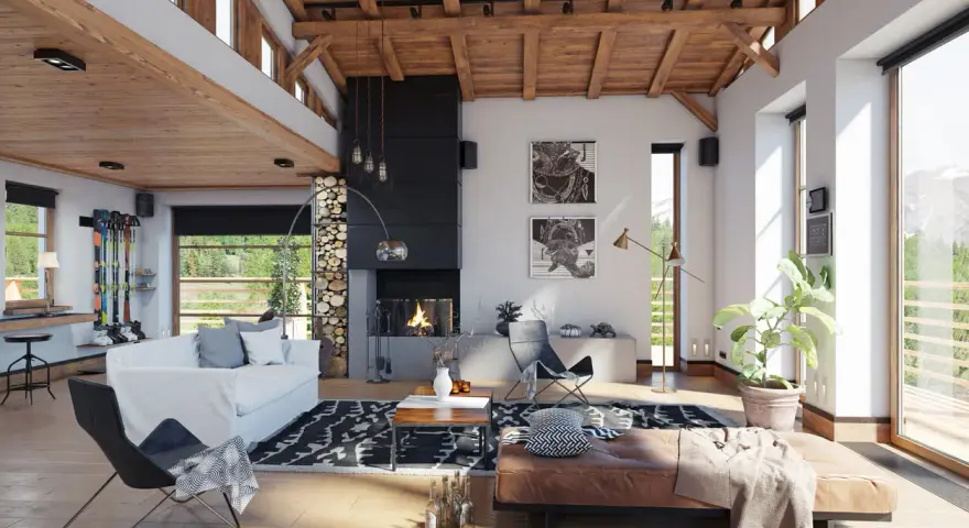 Ambiance chaleureuse d'un **chalet intérieur** avec cheminée, canapé blanc, fauteuil design et vue sur la montagne.