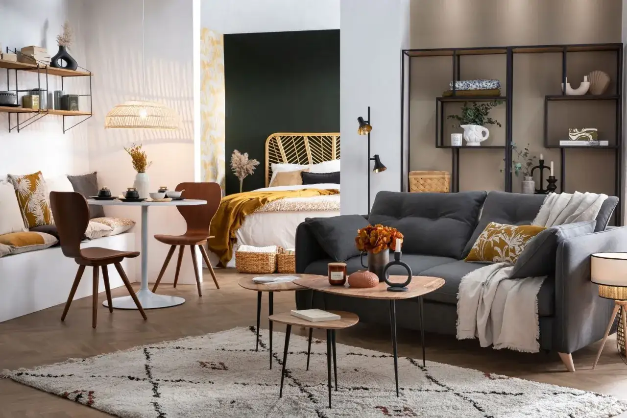 Am&eacute;nagement d'un studio cosy : un coin repas, un lit douillet et un salon invitant.